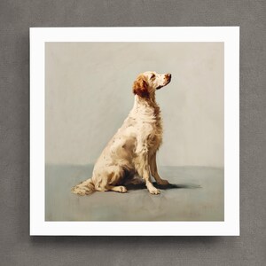 May include: A print of a dog, likely an English Setter, in a seated pose. The dog has a white coat with brown markings on its head and body. The artwork is set against a muted background, giving it a classic, vintage feel.