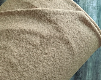 May include: Close-up of a folded piece of tan fabric with a textured surface. The fabric is a warm, neutral color, and the texture is visible throughout the material. The number "1641" is printed in white on the bottom right corner.