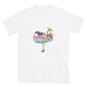 May include: White t-shirt featuring a cartoon illustration of a boat with the text "The Implication". The boat has a green alien figure, flames, and is supported by a pair of yellow legs wearing red high heels. The boat has a pink railing.