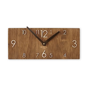 May include: A wooden wall clock with a brown wood grain finish. The clock face has white numbers and black hands. The clock is rectangular and has a simple design.