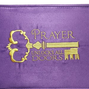 May include: Purple velvet pillow with gold embroidery of a key and the text "PRAYER UNLOCKS ALL DOORS".