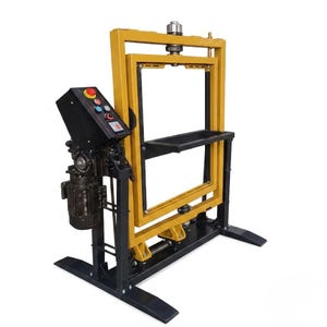 May include: A yellow and black industrial machine with a rectangular frame. The machine has a control panel with buttons and a motor on the side. The frame has a black tray and is supported by a black base.
