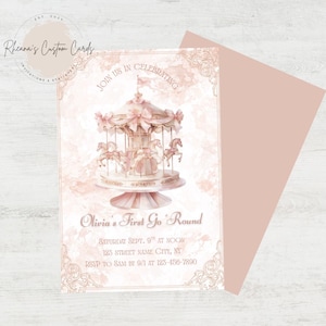 May include: A blush pink invitation card with a carousel illustration. The card reads "Olivia's First Go 'Round" and includes event details. A matching envelope is visible. The card is from Rheana's Custom Cards.