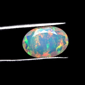 5 Ct Ethiopian Opal Gemstone: 17x11.8x5.3 mm AAA Faceted Oval With Rainbow Fire