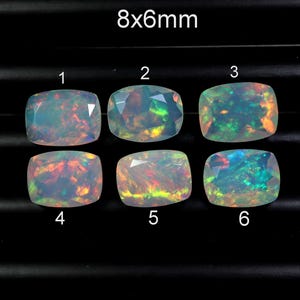 May include: Six cushion-cut opals arranged in two rows of three, each measuring 8x6mm. The gemstones display a translucent base with iridescent flashes of red, orange, green, and blue. Each stone is numbered from one to six for identification.