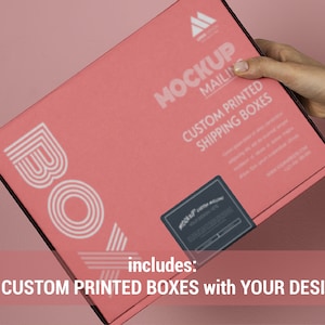 May include: A pink cardboard box with the text "MOCKUP MAILING" and "CUSTOM PRINTED SHIPPING BOXES" printed on the front. The box includes 25 custom printed boxes with your design.