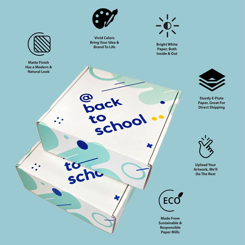 May include: Two white cardboard boxes with a colorful abstract design and the text "@back to school" and "to sch" printed on them. The boxes are stacked on top of each other.