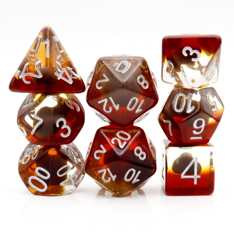May include: Set of seven brown and clear dice with white numbers. The dice are in a variety of shapes, including a d4, d6, d8, d10, d12, and d20.