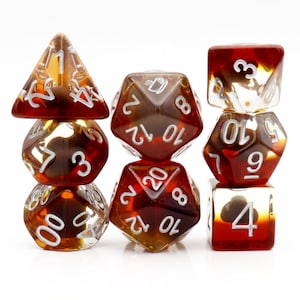 May include: Set of seven brown and clear dice with white numbers. The dice are in a variety of shapes, including a d4, d6, d8, d10, d12, and d20.