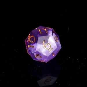 May include: A purple and white d6 dice with gold numbers. The dice has a swirl pattern and is made of clear plastic.