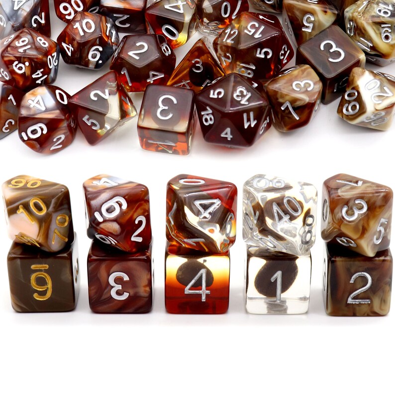 May include: A set of 10 brown and clear dice with white numbers. The dice are made of a translucent material with swirls of brown and clear plastic. The dice are arranged in a row, with the numbers facing up.