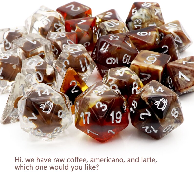 May include: A collection of brown and clear dice with white numbers and a coffee cup design. The dice are scattered on a white surface.