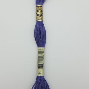 May include: A skein of deep purple embroidery floss featuring a paper label with the text DMC, 25, 8m/8.7yd, and the number 32. The thread is wound into a long, twisted bundle, showcasing a vibrant, solid violet color throughout the entire length.