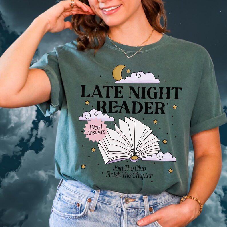 May include: Green t-shirt with the text "LATE NIGHT READER" and an illustration of an open book, moon, stars, and clouds. The shirt also includes the phrases "I Need Answers" and "Join The Club Finish The Chapter".