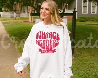 May include: White sweatshirt with a pink heart design that says "Romance Readers Book Club".
