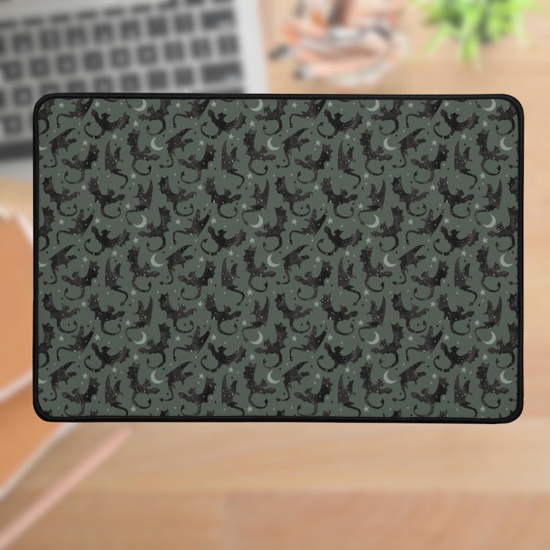 May include: A dark green mouse pad with a repeating pattern of black bats and white crescent moons.