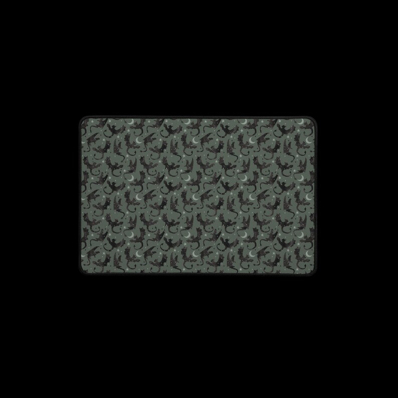 May include: A dark green fabric with a repeating pattern of black dragons and crescent moons.