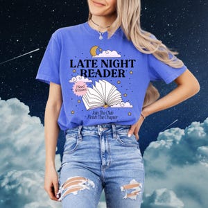 May include: A blue t-shirt with the words "LATE NIGHT READER" in white, along with an illustration of an open book, moon, and stars. The shirt also has the phrases "I Need Answers" and "Join The Club Finish The Chapter".
