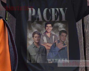 Op de afbeelding: Zwart T-shirt met een vintage-stijl grafische afbeelding van drie mannen. De afbeelding bevat de tekst "Pacey" en "Witter".