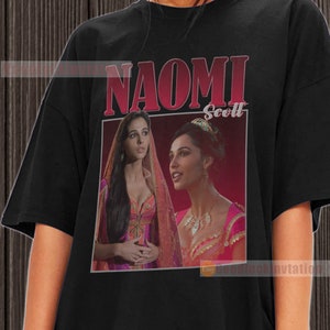 May include: Black t-shirt with a graphic print of Naomi Scott as Jasmine from the movie Aladdin. The graphic is in a retro style with the text "NAOMI Scott" in red and white.
