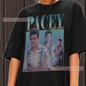 May include: Black t-shirt featuring a vintage-style graphic of a young man with the text "Pacey Witter" printed on it.