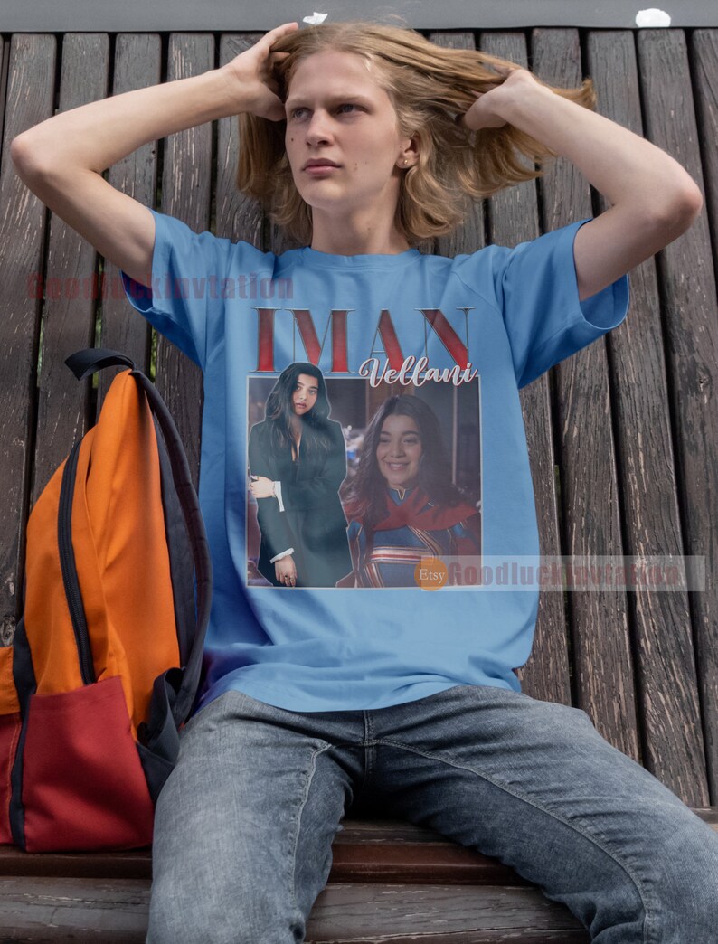 May include: A light blue t-shirt featuring a vintage-style image of two women. The image includes the text "Iman Vellani" and the Etsy logo.
