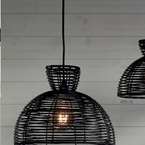 Pode incluir: Luminária pendente preta com um abajur de vime tecido. A luz está pendurada em um cabo preto e tem uma lâmpada visível.