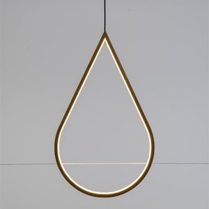 May include: A gold-colored teardrop-shaped pendant light fixture with a thin, horizontal shelf inside the teardrop.