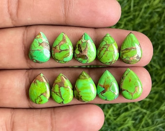 May include: Ten green and copper pear-shaped turquoise cabochons, each with a unique pattern of copper inclusions.