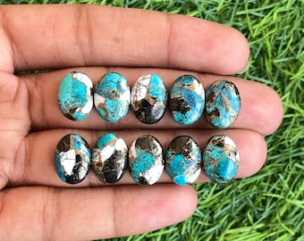 May include: Eight oval-shaped turquoise cabochons with black and white marbling. The stones are approximately 1 inch long and 1/2 inch wide.