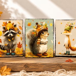 May include: Three autumn-themed wooden panels featuring woodland creatures. A raccoon, squirrel, and fox are depicted wearing hats and surrounded by fall leaves. The artwork has a vintage, watercolor style with warm colors.