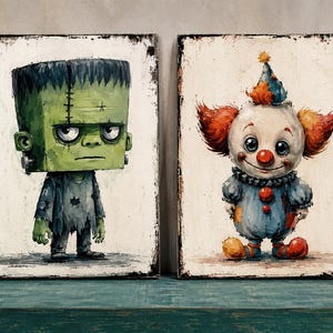 May include: Two rectangular wall art prints featuring stylized illustrations. The left print depicts a green, square-headed creature with dark hair and a tattered grey suit. The right print shows a clown with orange hair, a blue outfit, and a red nose.