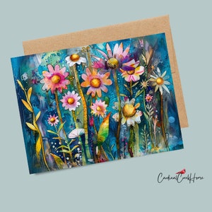 May include: A greeting card featuring a watercolor painting of colorful flowers in shades of pink, yellow, and white against a teal background. The card is paired with a brown envelope. The text "Cardinal Creek Home" is in the bottom right corner.