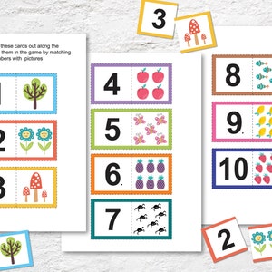 May include: A set of 10 colourful cards with numbers 1 through 10 and corresponding pictures. The cards are designed for a matching game to help children learn to count.