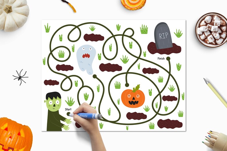 May include: A Halloween-themed maze game with a green monster at the start and a pumpkin at the finish. The maze path is drawn in black and the background is white. The maze features a ghost, a tombstone with the text "RIP", and brown dirt patches.