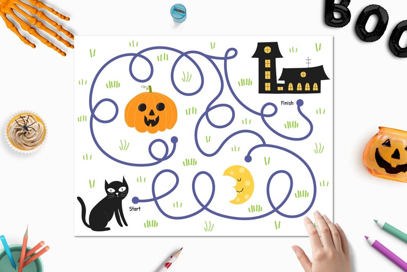 May include: A Halloween-themed maze game with a black cat starting at "Start" and a haunted house with "Finish" at the end. The path winds through a pumpkin, a crescent moon, and green grass.