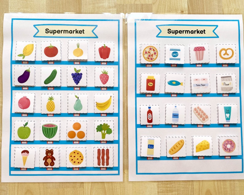 May include: Two colorful charts with the word "Supermarket" at the top. The charts are divided into squares, each containing a different image of a food item. The left chart features fruits, vegetables, and other grocery items. The right chart features packaged food items, such as pasta, salt, and eggs.
