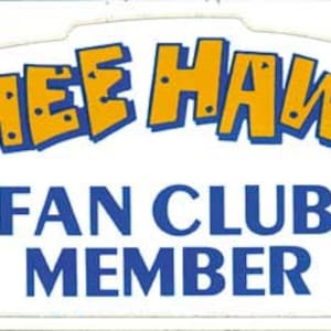May include: A white rectangular sticker with the words "Hee Haw Fan Club Member" in blue and yellow lettering.