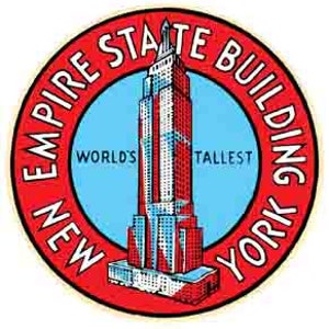 May include: A red and white circular sticker with the words "Empire State Building New York" around the edge. The center of the sticker features a blue circle with a stylized image of the Empire State Building and the words "World's Tallest".