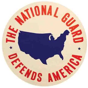 May include: A white circle with red text that reads "The National Guard Defends America". A blue outline of the United States is in the center of the circle.