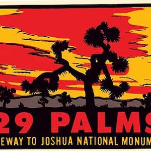 May include: A vintage travel poster with a red, yellow, and black color scheme. The poster features a silhouette of a Joshua Tree against a sunset sky. The text "29 PALMS GATEWAY TO JOSHUA NATIONAL MONUMENT" is printed in red at the bottom of the poster.