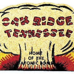 May include: A vintage-style illustration of a mushroom cloud with the text "Oak Ridge Tennessee" and "Home of the Atomic Bomb" in red lettering.