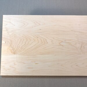 May include: A plain, light wood panel with a natural wood grain pattern.