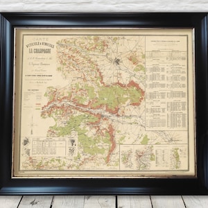 May include: A vintage map of the Champagne region of France, showing the vineyards and wine-producing areas. The map is in French and includes a key with different colours representing different types of grapes. The map is framed in a black frame.