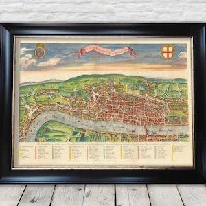 May include: Framed vintage map of London, featuring a detailed illustration of the city with the Thames River. The map is in a black frame and includes text and decorative elements.
