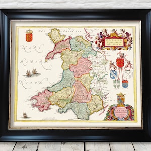May include: An antique map of Wales, printed in black, red, green, and yellow, with a title in Latin, "WALLIA PRINCIPATUS WALIAE", and a decorative border of coats of arms and cherubs.