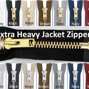 May include: A close-up of a zipper with a gold slider and teeth. The zipper is shown in eight different colours: white, black, beige, brown, grey, navy, wine, and black. The text "Extra Heavy Jacket Zippers" is displayed above the zipper.