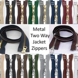 May include: Assortment of metal two-way jacket zippers in various colors, including beige, black, brown, green, grey, navy, red, and white. The zippers have gold and silver pulls.