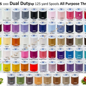 May include: A collection of 125-yard spools of Coats Dual Dutyxp All Purpose Threads in a variety of colors. The spools are arranged in rows and columns, with each color labeled with a number.