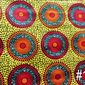 May include: Yellow fabric with a repeating pattern of red, orange, green, and white concentric circles. The fabric has a #13 printed on it.